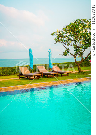 chair pool and umbrella around swimming pool chair pool and umbrella around swimming pool 112688315