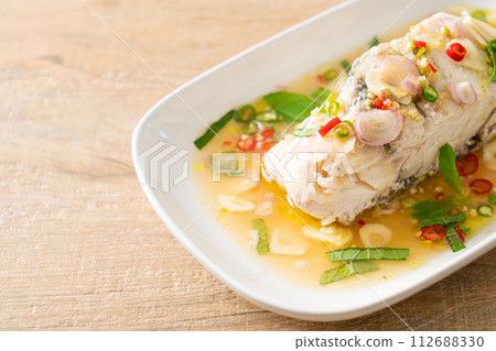 steamed sea bass fish with herbs 112688330
