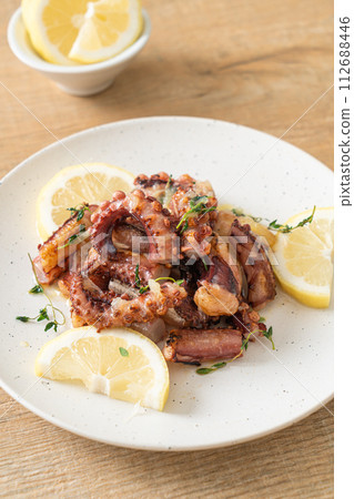 grilled octopus or squid with butter lemon sauce 112688446