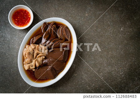 stewed duck offal in brown soup 112688483