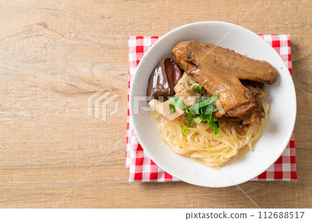 dried noodles with braised duck in white bowl 112688517