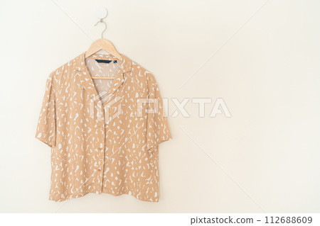 beautiful woman shirt hanging on wall beautiful woman shirt hanging on wall 112688609