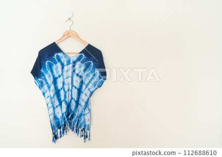 tie dye shirt hanging on wall 112688610