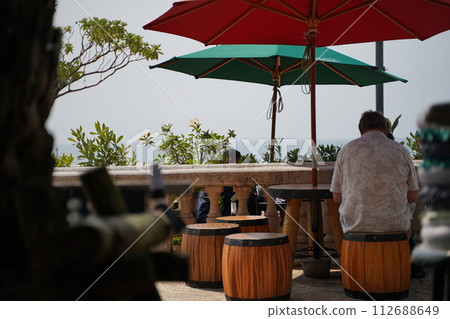 Couple looking at garden umbrella Couple looking at garden umbrella 112688649