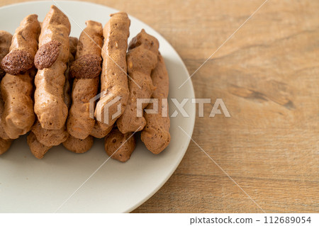 chocolate meringue stick on plate chocolate meringue stick on plate 112689054