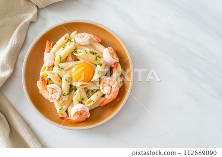 penne pasta white cream sauce with shrimps and egg 112689090