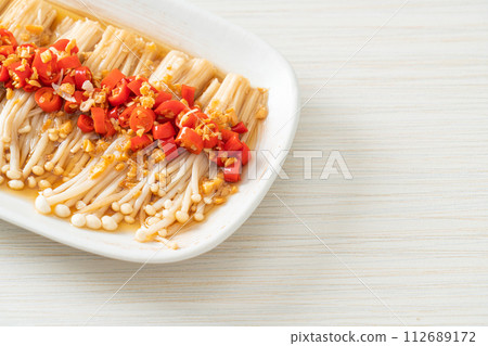 steamed golden needle mushroom or enokitake with soy sauce, chilli and garlic steamed golden needle mushroom or enokitake with soy sauce, chilli and garlic 112689172