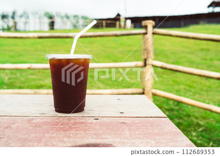 americano coffee on wood table with Mountain hill View background americano coffee on wood table with Mountain hill View background 112689353
