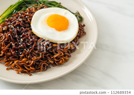 dried Korean spicy black sauce instant noodles with fried egg and kimchi dried Korean spicy black sauce instant noodles with fried egg and kimchi 112689354