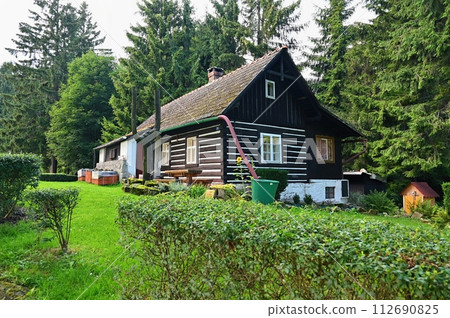 Beautiful old traditional house in the mountains in the Czech Republic. Cottage in nature. Beautiful old traditional house in the mountains in the Czech Republic. Cottage in nature. 112690825