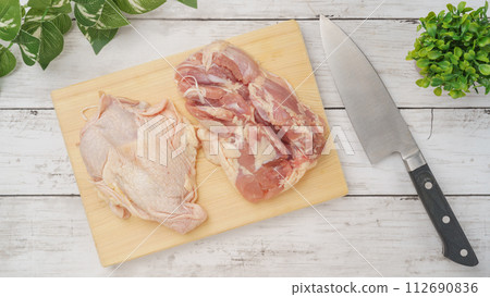 chicken thighs on a cutting board chicken thighs on a cutting board 112690836