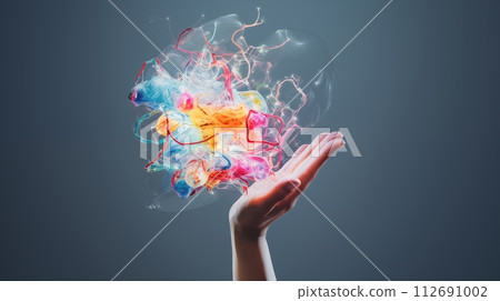 Energetic hand holds vibrant abstract colors, sparking imaginative ideas 112691002