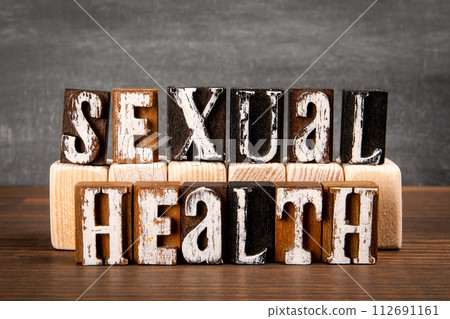 SEXUAL HEALTH Concept. Alphabet blocks on wood texture background 112691161