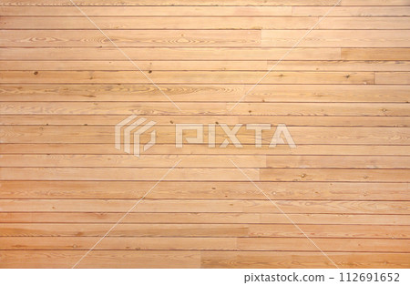 Texture of old wooden board of yellow color. Horizontal background with retro wood planks. Wall with pine boards trim 112691652