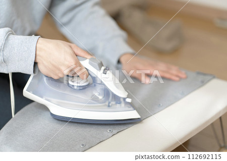 Man ironing body parts iron 112692115
