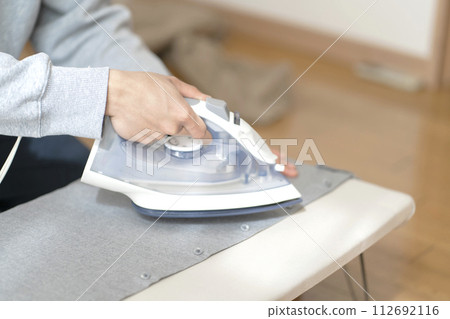 Man ironing body parts iron 112692116