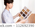 A woman looking at flooring samples 112692390