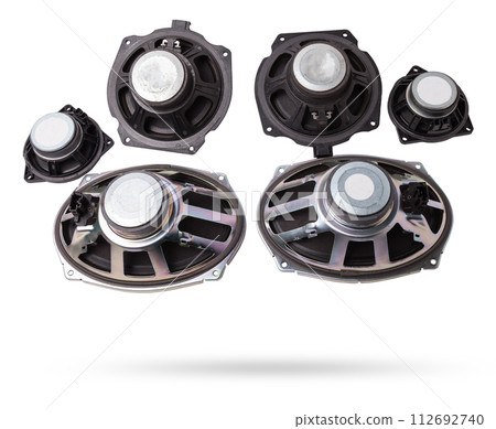 Two speakers of an acoustic system - an audio for playing music in a car interior on a white isolated background in a photo studio. Spare parts for auto repair in a workshop or for sale for tuning 112692740