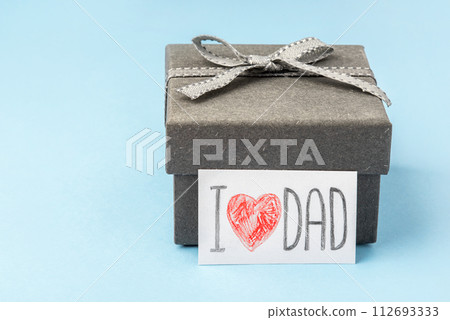 A gray gift box with a Father's Day greeting card. A gray gift box with a Father's Day greeting card. 112693333