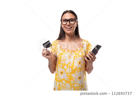 European woman with straight flowing black hair dances holding a plastic salary card and a 112693737