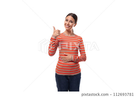surprised young adult woman dressed in an orange sweater shows like and class with her hands surprised young adult woman dressed in an orange sweater shows like and class with her hands 112693781