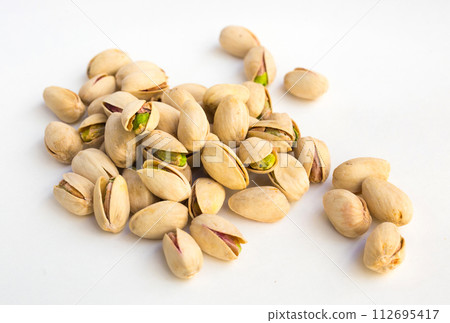 Roasted pistachios on white background 112695417