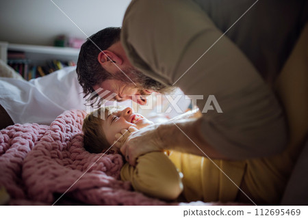Father an son playing, tickling, laughing together. Boys dad. Unconditional paternal love, Father's Day concept. 112695469