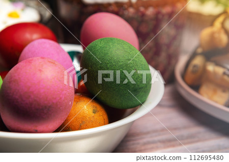 Painted eggs on the Easter holiday table. Easter brunch with eggs and pastries on the holiday table. Painted eggs on the Easter holiday table. Easter brunch with eggs and pastries on the holiday table. 112695480