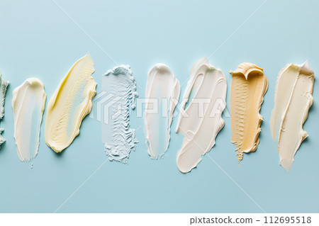 AI-generated content. Swatches of different makeup products (different colors and textures) on solid color background 112695518