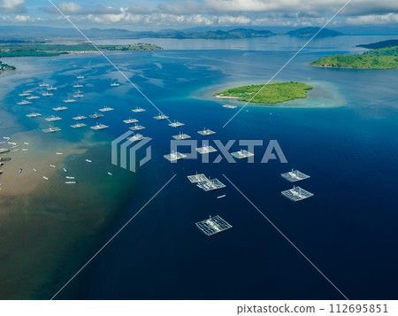 Local fishing boats in blue ocean near Sumbawa. Drone view. Local fishing boats in blue ocean near Sumbawa. Drone view. 112695851