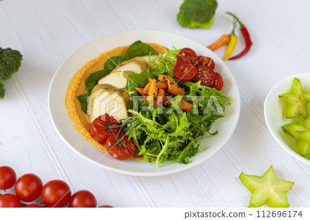 Baked chicken with vegetables, pumpkin puree and arugula. Keto diet food. 112696174