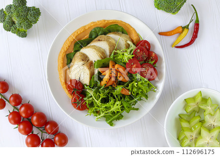 Baked chicken with vegetables, pumpkin puree and arugula. Keto diet food. 112696175