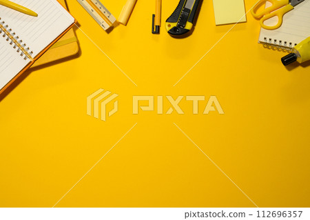 School supplies on yellow background. Flat lay, top view with copy space School supplies on yellow background. Flat lay, top view with copy space 112696357