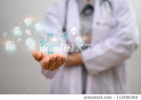 Doctor holding holding blue virtual plus sign. Health insurance and medical check up concept Doctor holding holding blue virtual plus sign. Health insurance and medical check up concept 112696368