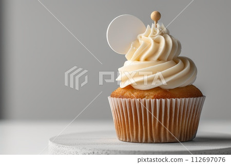 Cupcake with white cream and an inscription plate on a white background Cupcake with white cream and an inscription plate on a white background 112697076