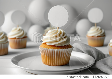 Cupcake with white cream and an inscription plate on a white background Cupcake with white cream and an inscription plate on a white background 112697078