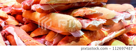 Tapas and pinchos at a food market in Spain. Traditional Spanish gastronomy Tapas and pinchos at a food market in Spain. Traditional Spanish gastronomy 112697487