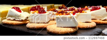 Tapas and pinchos at a food market in Spain. Traditional Spanish gastronomy Tapas and pinchos at a food market in Spain. Traditional Spanish gastronomy 112697488