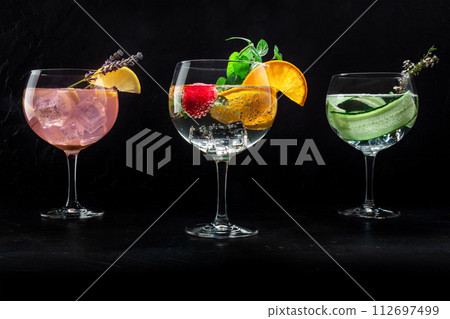 Fancy cocktails with fresh fruit. Gin and tonic drinks with ice at a party 112697499