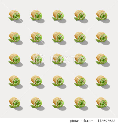 Pattern of sweet rolls with green cream and soft cheese isolated on white background. 112697688
