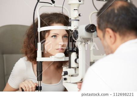 looking into eye test machine looking into eye test machine 112698221