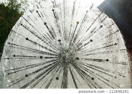Waterdrops of beautiful ball fountain in summer park. 112698281