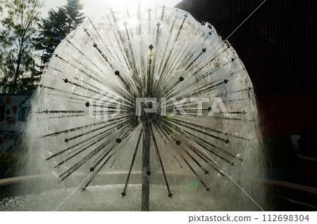 Waterdrops of beautiful ball fountain in summer park. 112698304