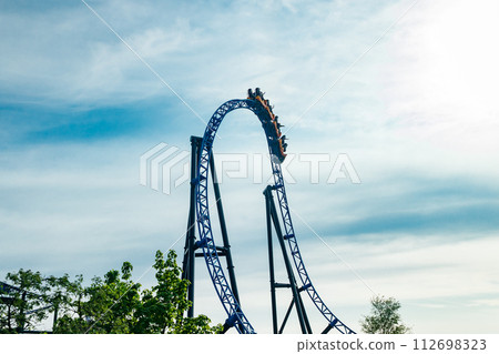 Ride roller coaster in motion on sky background in amusement park 112698323