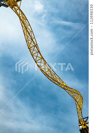 Empty ride roller coaster in amusement park on blue sky background. 112698330