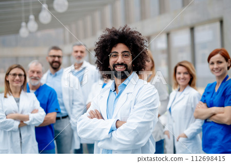 Portrait of team of doctors. Healthcare team with doctors, nurses, professionals in medical uniforms in hospital. Portrait of team of doctors. Healthcare team with doctors, nurses, professionals in medical uniforms in hospital. 112698415