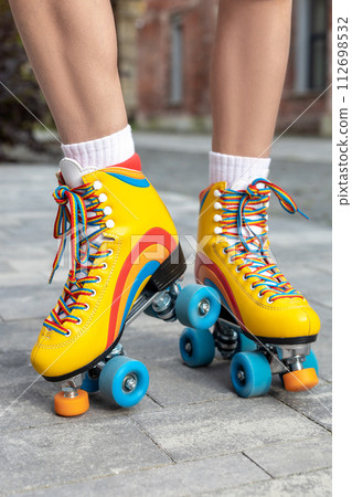 Woman trying on her new rollerblades 112698532