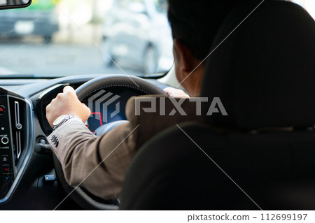 Businessman driving a car, hand Businessman driving a car, hand 112699197
