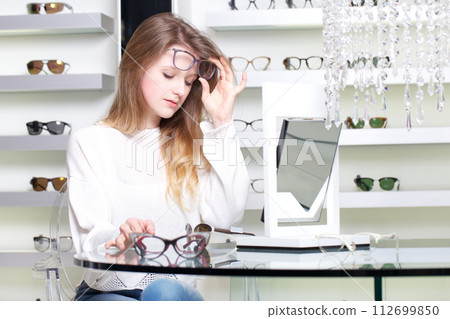 pretty girl buy a new pair of eyeglasses pretty girl buy a new pair of eyeglasses 112699850