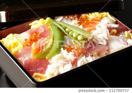 Chirashi sushi with various ingredients taken on a black background 112700737